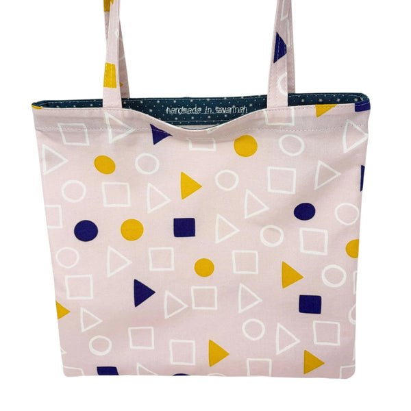 mmb by hand handmade fabric tote bag in light pink with yellow and navy geometric shapes and navy star-pattern lining