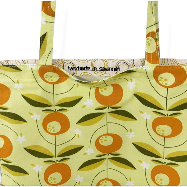 mmb by hand organic cotton tote bag in tang orange and green floral print with handmade in savannah interior label